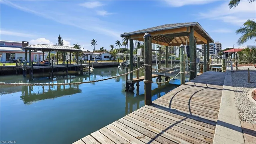 Dock area with a water view and boat lift - Virtually Edited Image