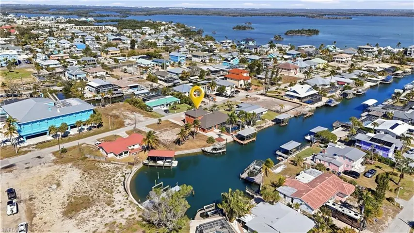 View of property location featuring a large body of water and nearby suburban area - Virtually Edited Image