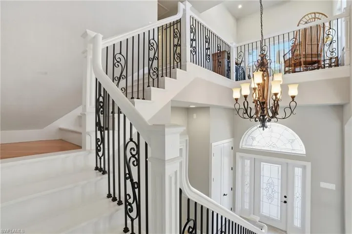 Foyer with a high ceiling and a chandelier - Virtually Edited Image