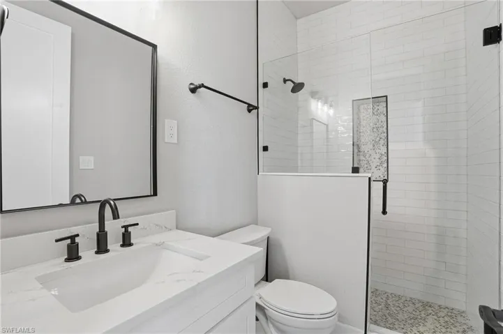 Bathroom with a stall shower and vanity - Virtually Edited Image