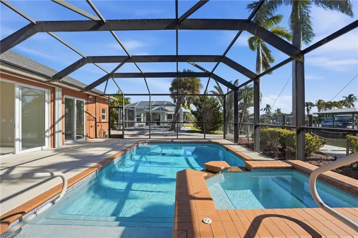 Integrated pool / hot tub with a lanai and a sunroom - Virtually Edited Image