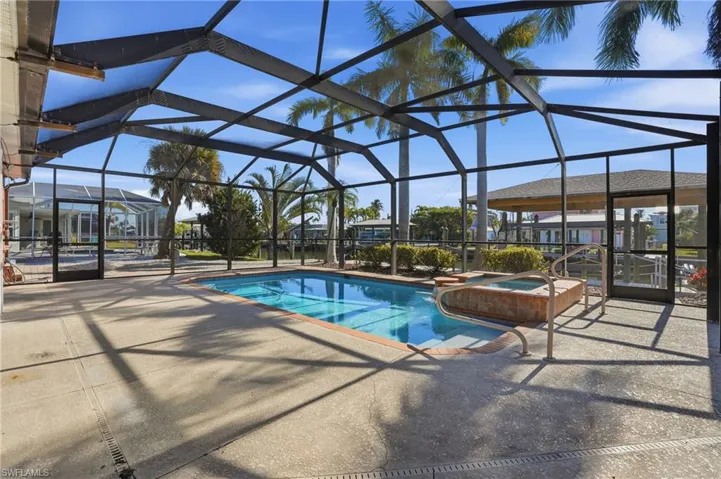 Relaxing pool / spa with a sunroom, a lanai, and a patio - Virtually Edited Image