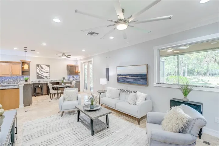 Living room and eat in kitchen, beautiful modern fixtures and voice controlled lighting, surround sound and crown molding.