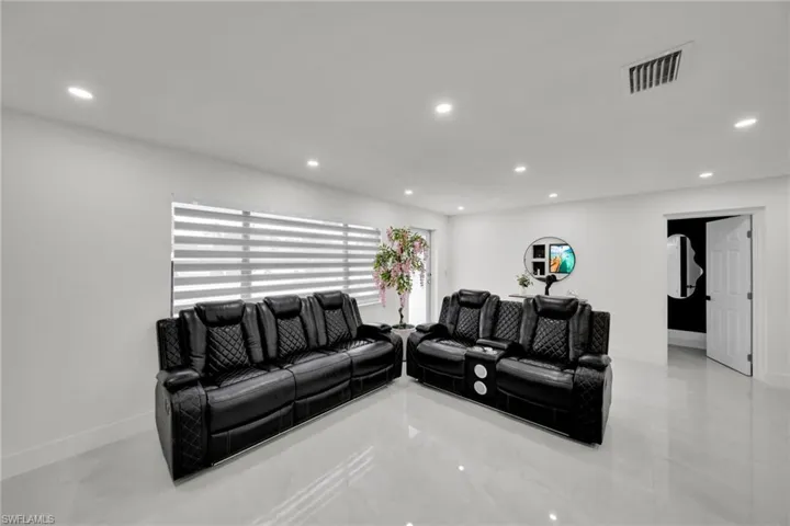 Spacious interior featuring pristine white walls and high-gloss tile flooring