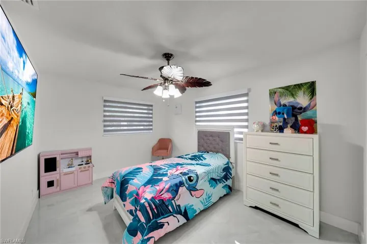 Recessed lighting, wood-finish ceiling fan, and two windows with horizontal blinds