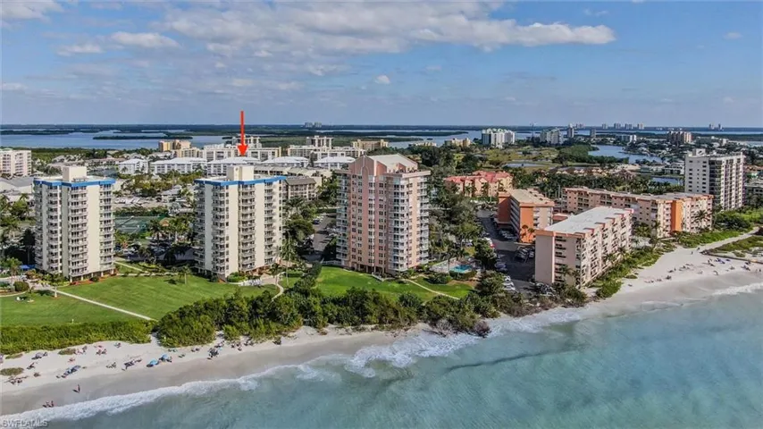 Birds eye view of property featuring a beach view and a water view