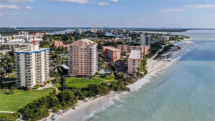 Birds eye view of property with a beach view and a water view