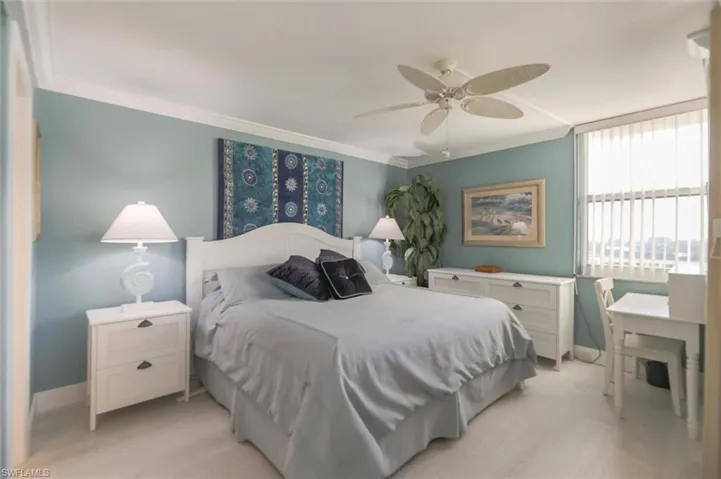 Bedroom featuring ceiling fan and crown molding
