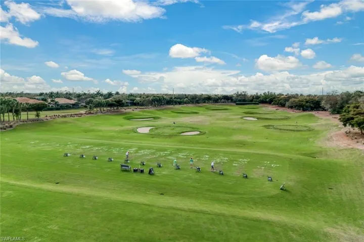 View of community featuring golf course view and view of wooded area