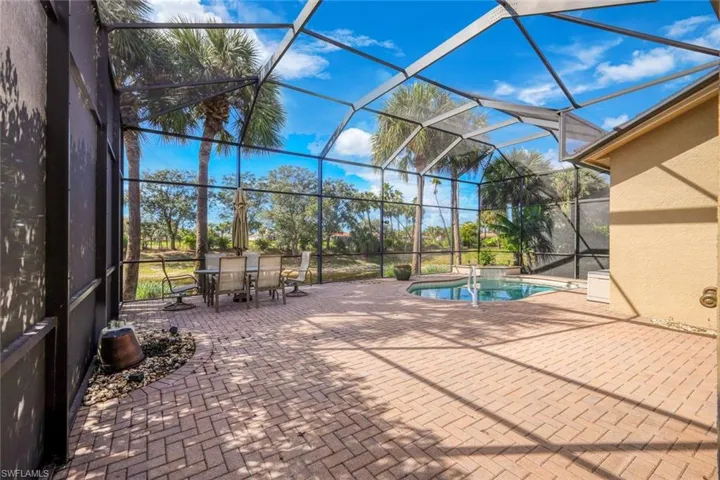 View of pool with a sunroom, a patio area, a lanai, and a pool with connected hot tub