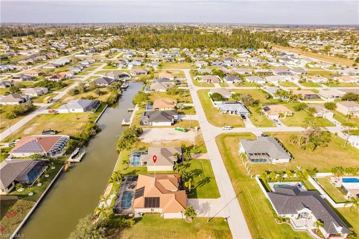 Aerial View North with the Canal, Dock, Pool & Lush Landscape!