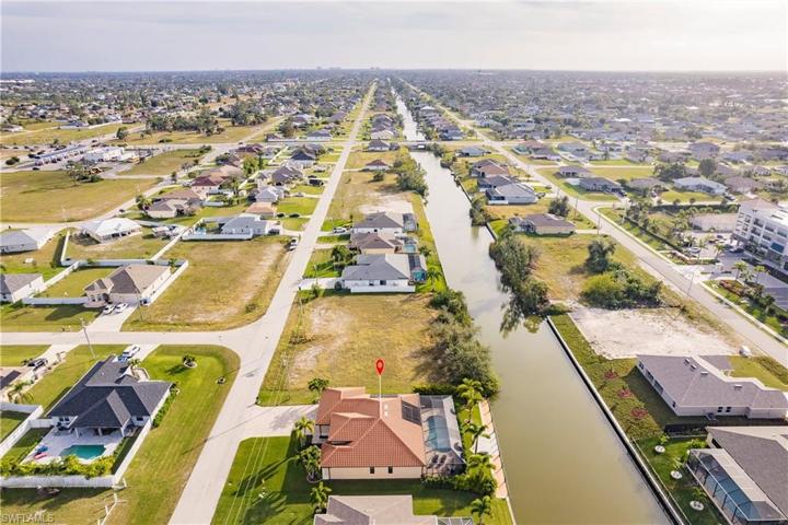 Aerial View South with the Canal, Dock, Pool & Lush Landscape!