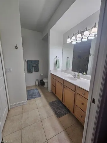 Bathroom featuring vanity, a stall shower, and light tile patterned flooring