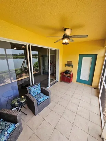 Sunroom / solarium featuring a water view