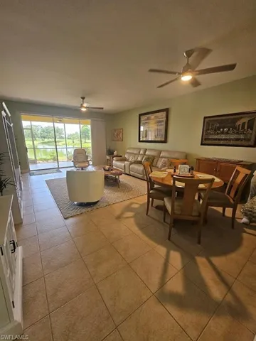Tiled dining room with a ceiling fan and a textured ceiling