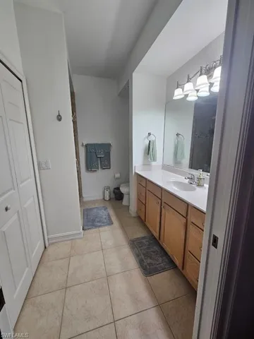Bathroom featuring vanity, a shower, and light tile patterned floors