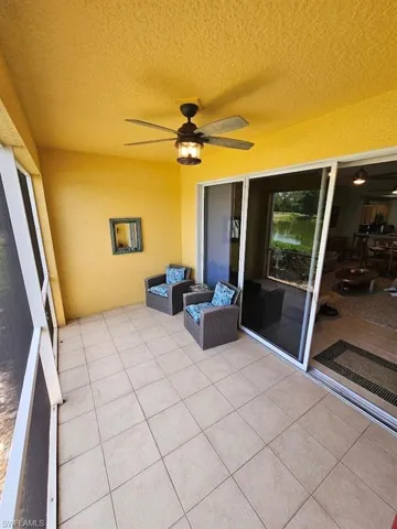 Sunroom featuring a ceiling fan