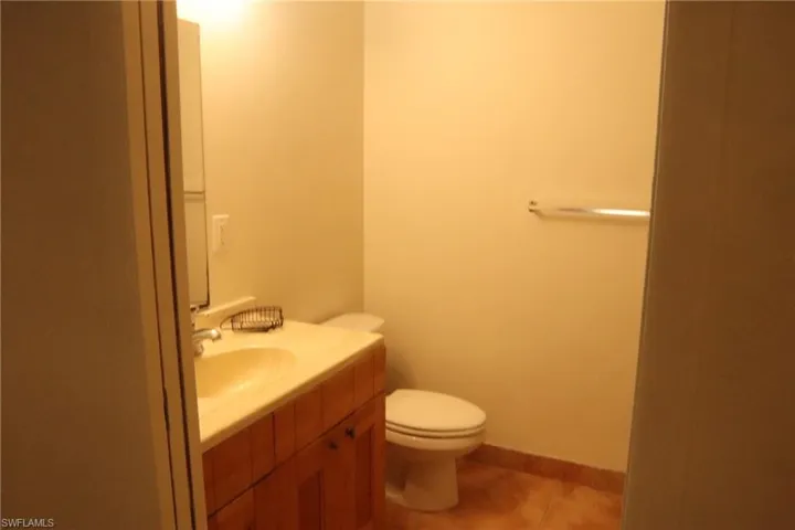Half bath featuring vanity and light tile patterned flooring