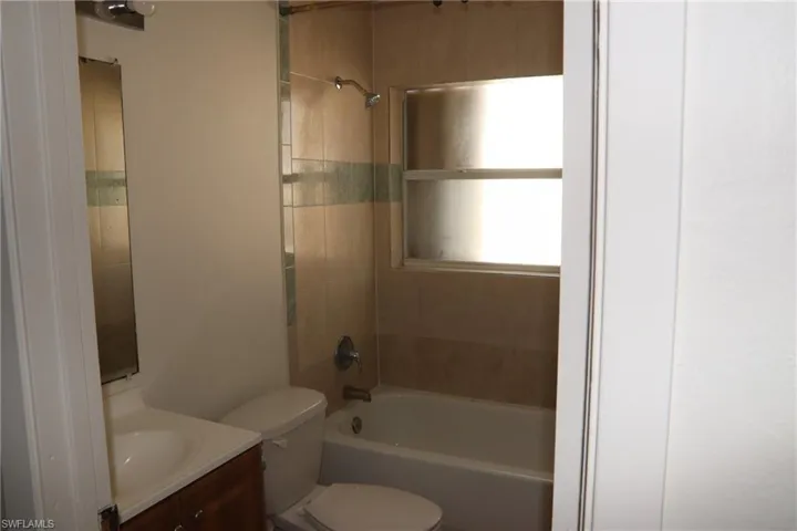 Bathroom featuring shower / tub combination and vanity