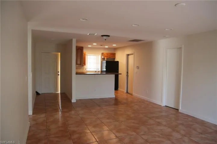 Unfurnished living room featuring recessed lighting and light tile patterned floors