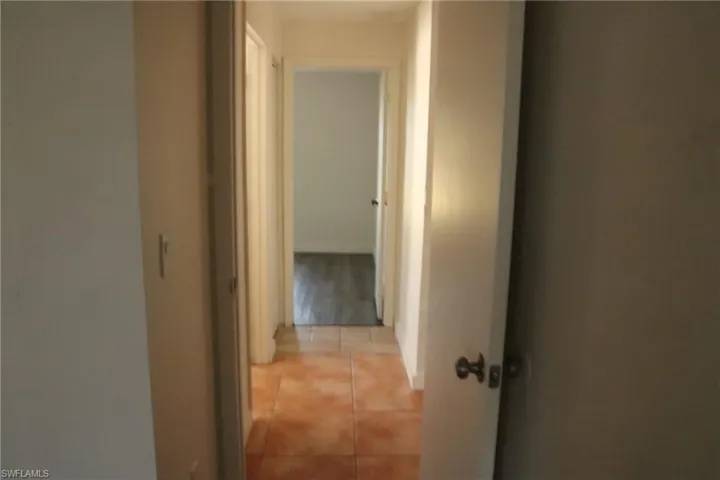 Corridor featuring light tile patterned floors