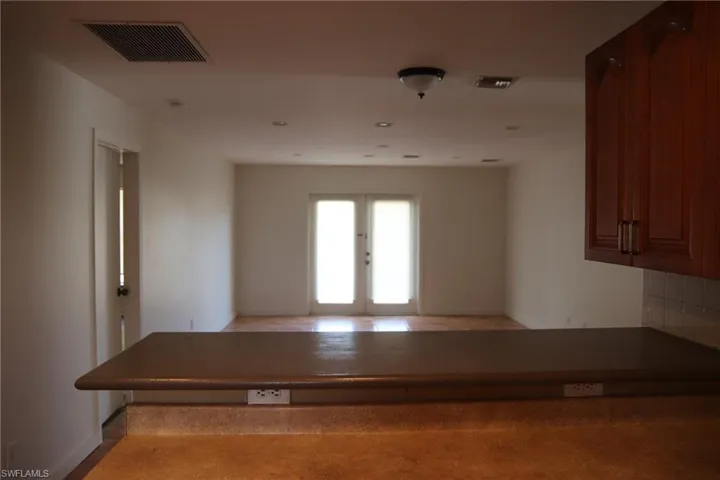 Hallway featuring french doors and recessed lighting