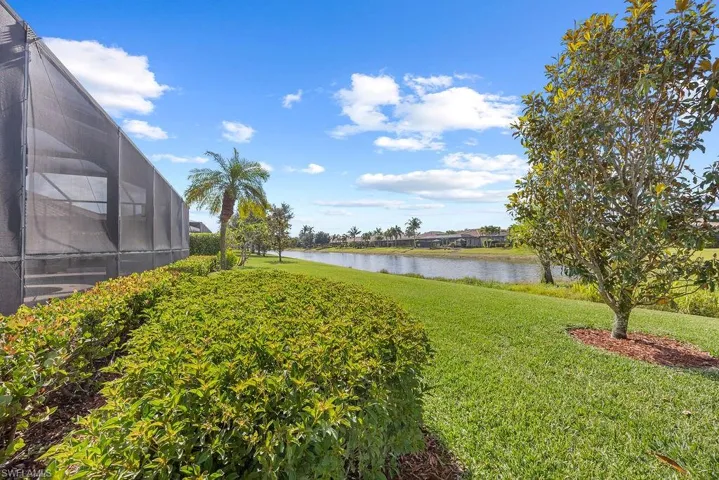 View of side yard with a water view