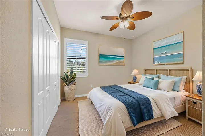 Carpeted bedroom featuring a closet and a ceiling fan