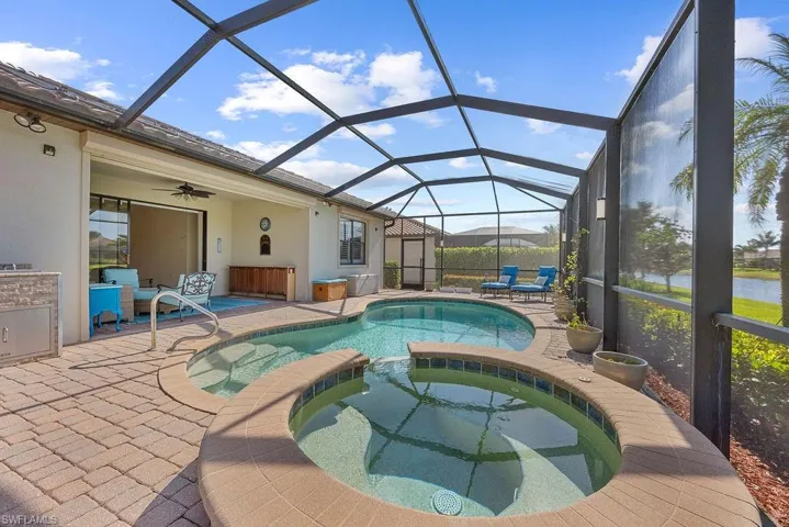 View of swimming pool with a patio area, a lanai, a pool with connected hot tub.