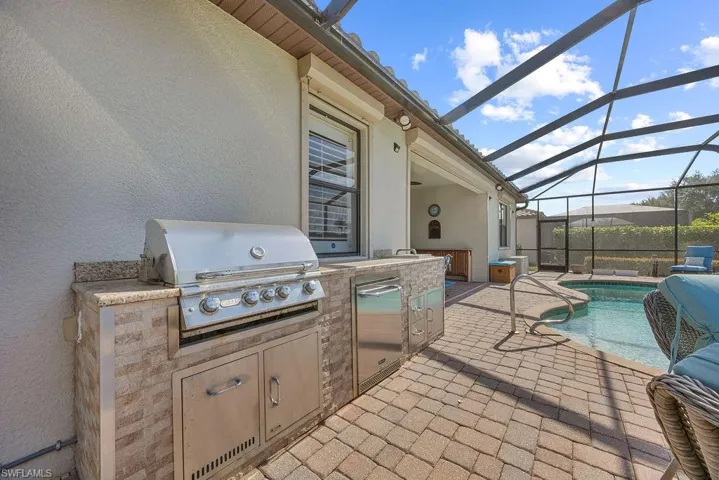 Outdoor kitchen is great for grilling, beverage fridge is built in!