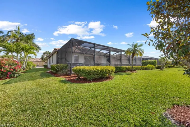 Back of home with screened pool enclosure.