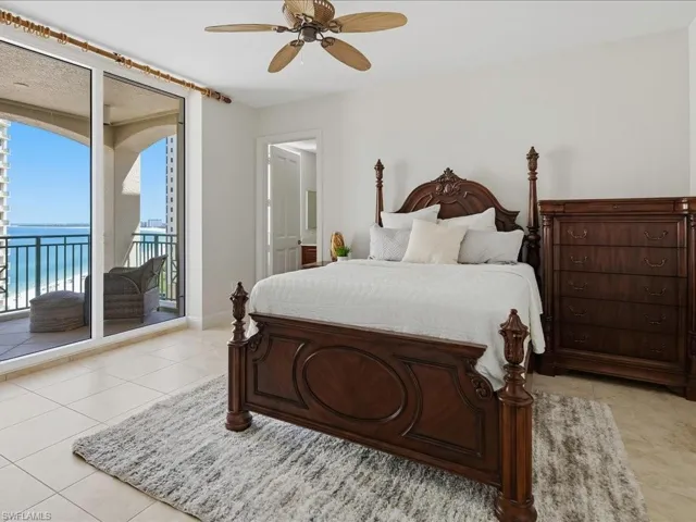 Spacious room featuring floor-to-ceiling sliding glass doors opening to a private balcony