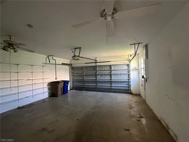 Garage featuring a garage door opener and ceiling fan