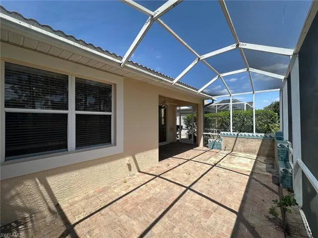 View of patio featuring a lanai
