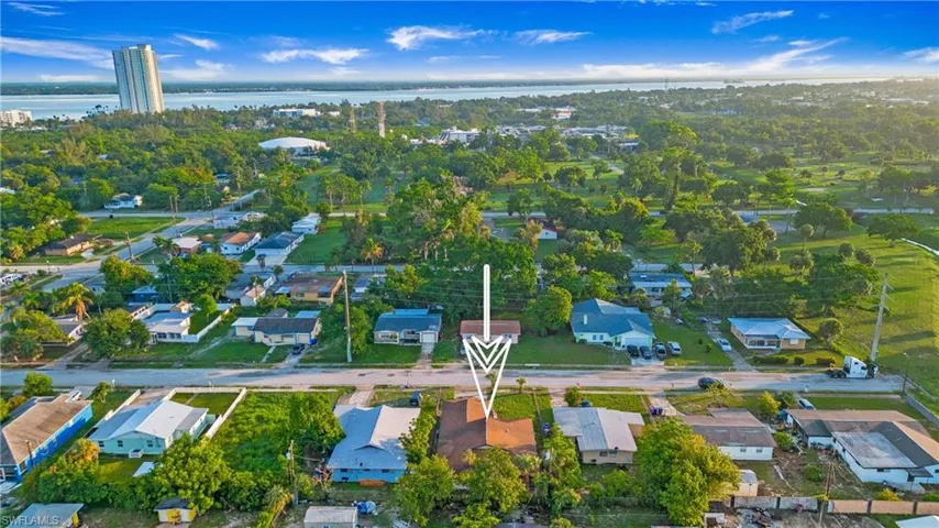 Aerial overview of property's location with nearby suburban area and a nearby body of water