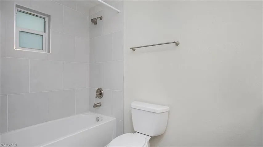 Full bathroom with toilet and bathtub / shower combination