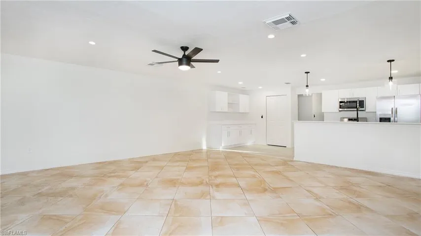 Unfurnished living room featuring recessed lighting and a ceiling fan