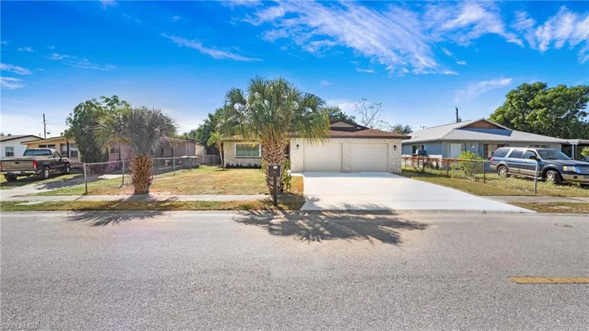 View of front of property featuring driveway and a garage
