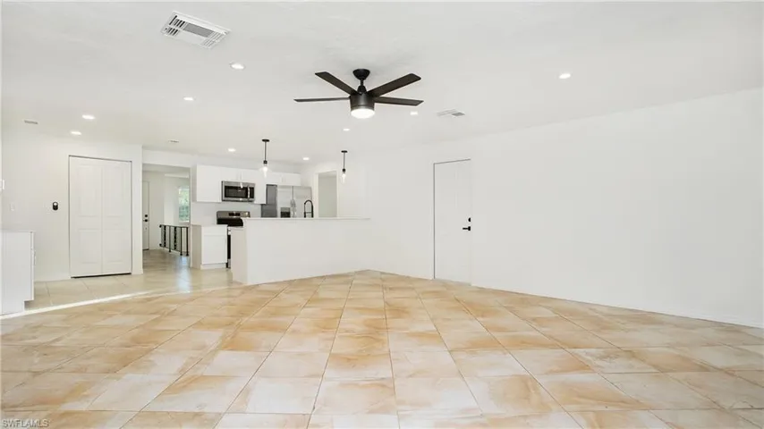 Unfurnished living room featuring recessed lighting, ceiling fan, and light tile patterned floors
