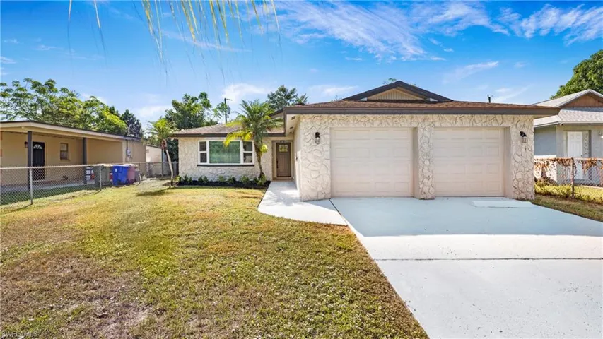 Single story home featuring stone siding, concrete driveway, an attached garage, and stucco siding