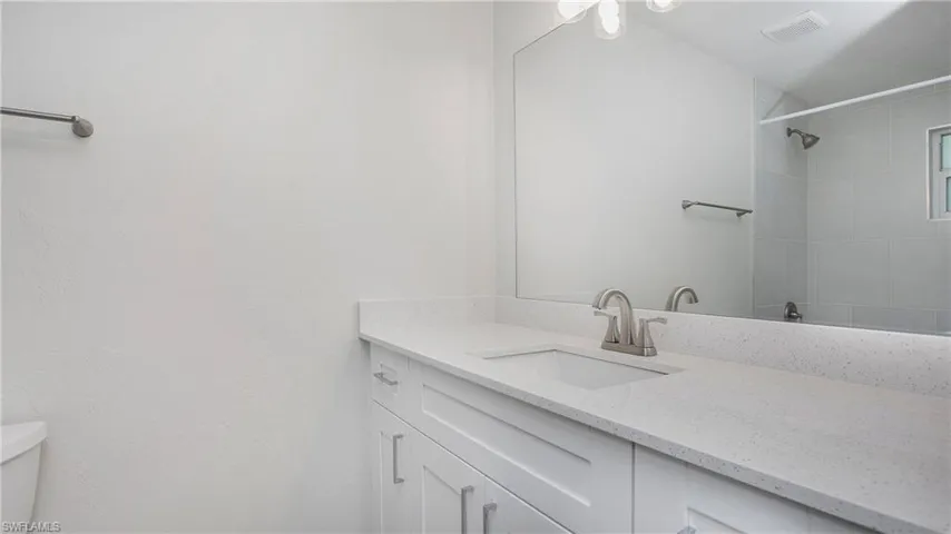Bathroom with vanity and a shower