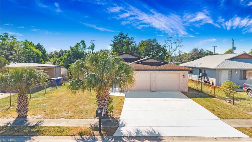 View of front of property featuring concrete driveway and an attached garage