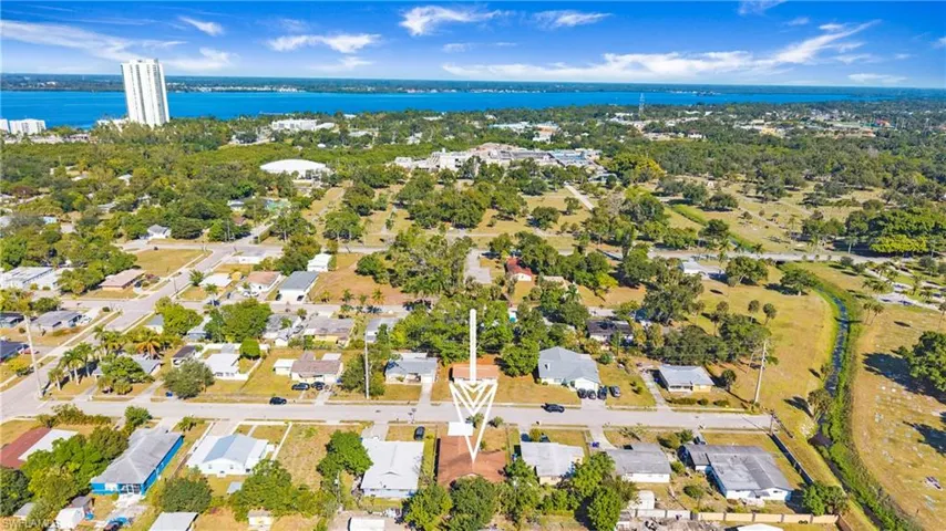 Aerial view of property's location with a large body of water