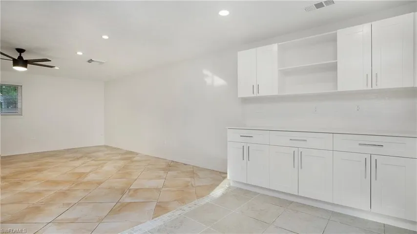 Kitchen featuring recessed lighting, white cabinets, ceiling fan, open shelves, and light countertops