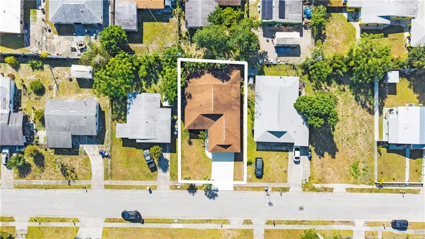 Aerial view of residential area with property parcel outlined