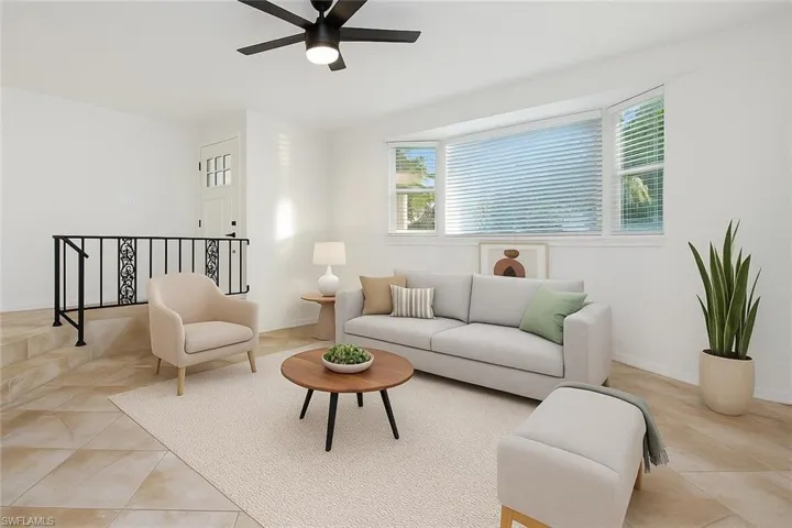 Virtually Staged Living area with a ceiling fan and light tile patterned flooring