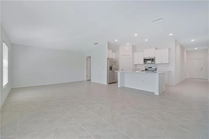 Unfurnished living room with light tile patterned floors