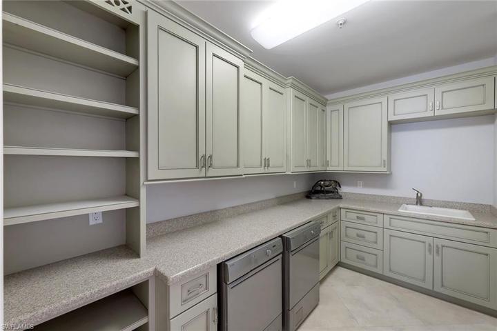 Large laundry with a tremendous amount of storage.