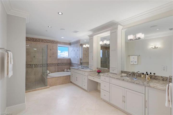 Huge bathroom with dual sinks, separate shower and soaking tub.