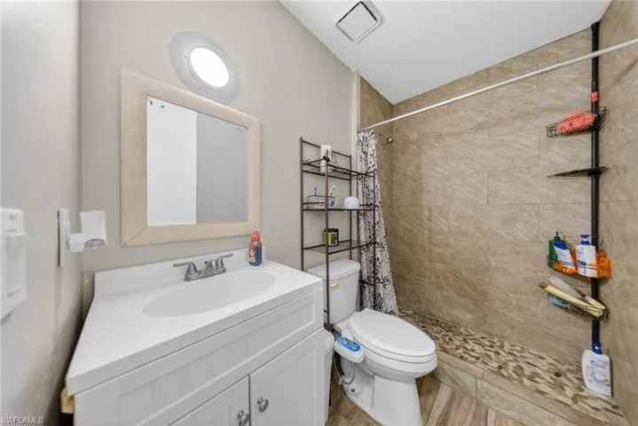 Bathroom featuring vanity and a stall shower